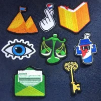 Fotografía de una tela de mezclilla que tiene varias figuras de diferentes colores hechas con bordado profesional.